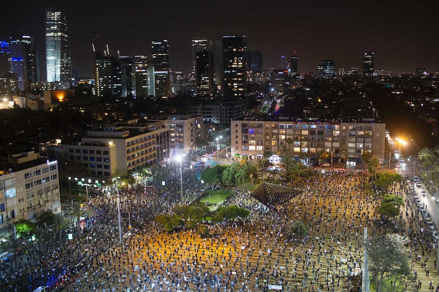Demonstrators stand apart to practice social distancing during a protest against Prime Minister Benjamin Netanyahu in Tel Aviv.