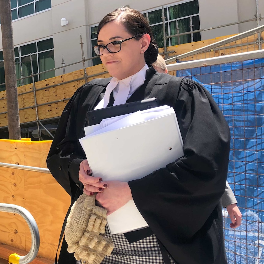A woman walks out of court