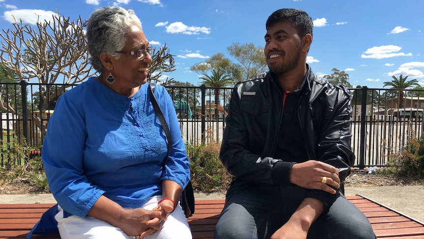 Antony Peries (right) talks with an interpreter at a legal service drop-in centre.