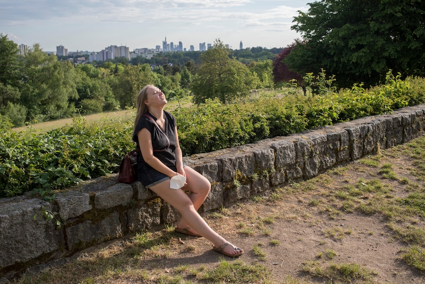 Sofie sits on the wall and is trying to take pleasure in the little things in life.