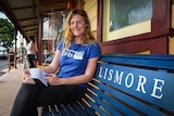 Maddy Braddon on bench seat at Lismore train station