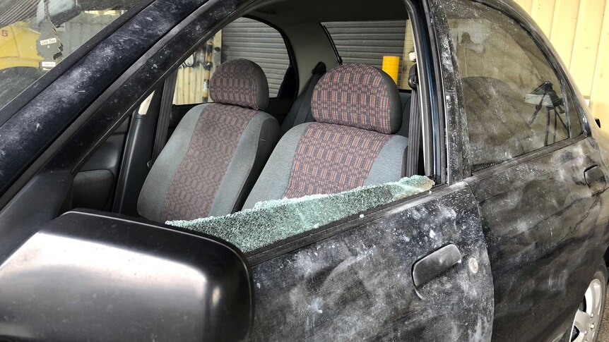 A smashed window of a vehicle that was rammed.
