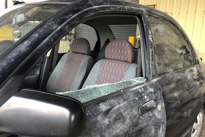 A smashed window of a vehicle that was rammed.