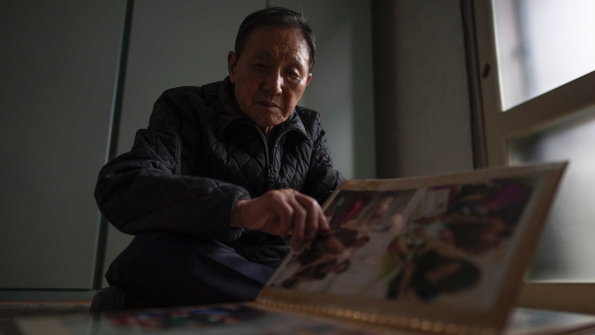 A man looks through a photo album.