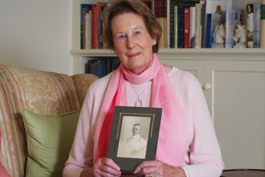 Leonie Matheson holds a photo of her grandfather, Victor Newland.