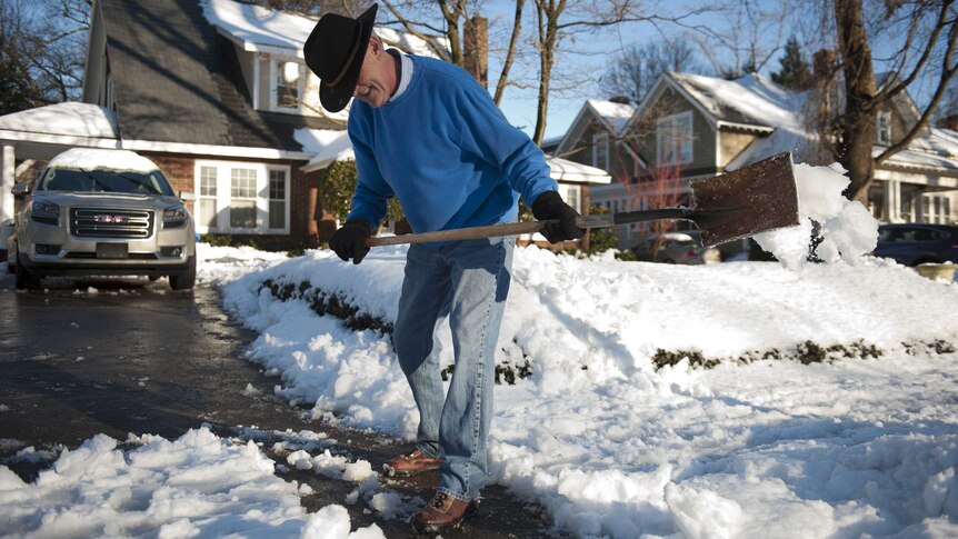 Man clears snow-covered driveway in North Carolina