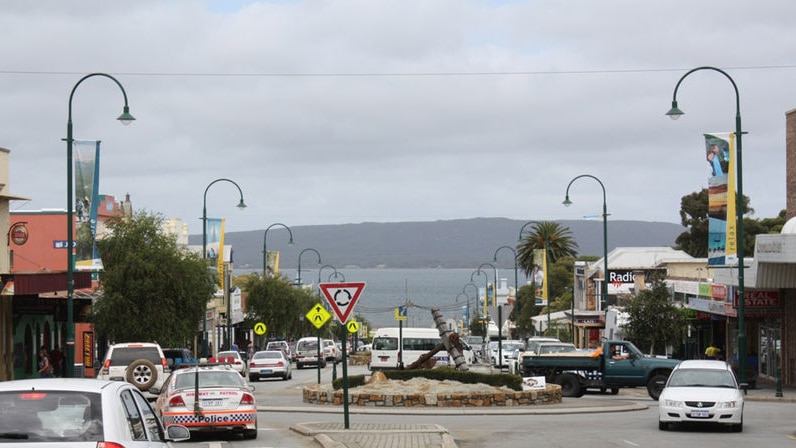 York Street in Albany with traffic and shops looking down to harbour.