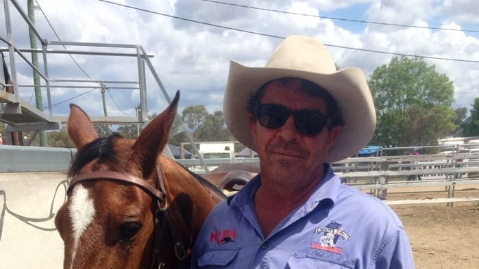 Campdrafter Ben Tapp stands next to his horse at the Warwick Showgrounds.