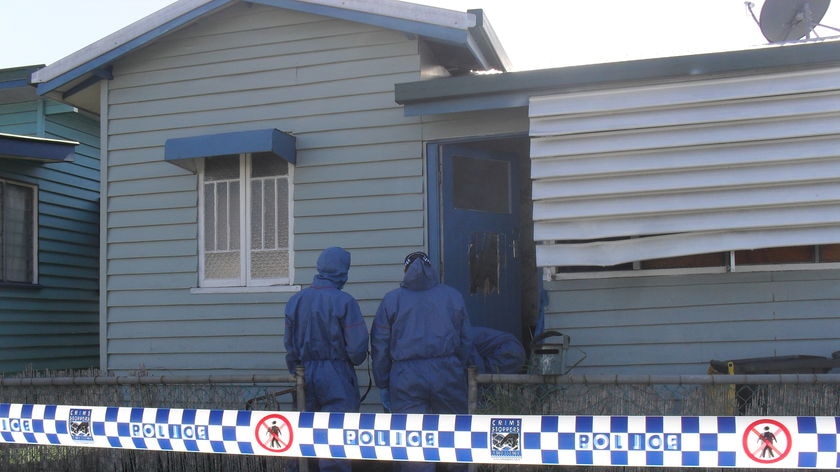Police forensic officers outside a house in Rockhampton where a man was shot.