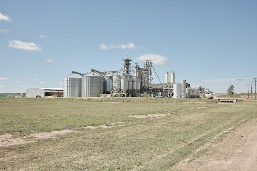 Wide landscape of silver factory with silos and tanks