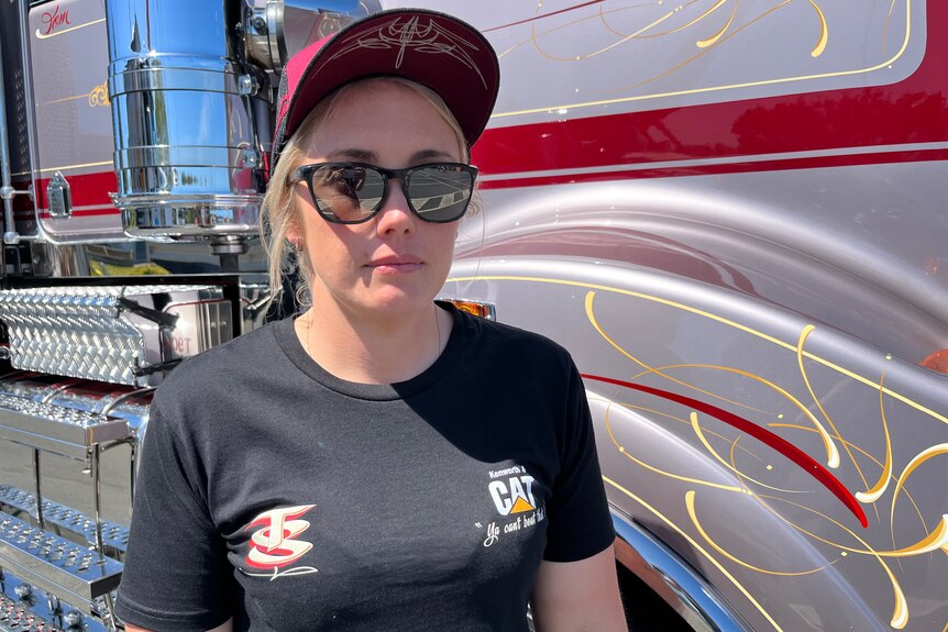 Brooke Seccombe stands in front of truck with blank face
