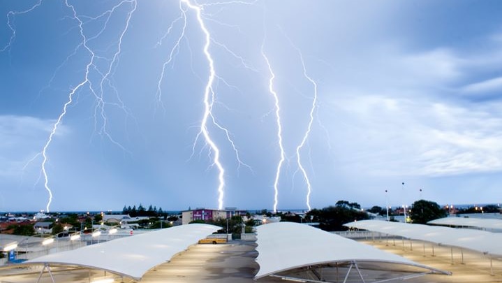 Lightning bolts over a shopping centre car park.