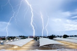 Lightning bolts over a shopping centre car park.