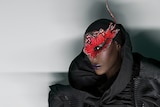 Jamaican singer Grace Jones wears a mask.