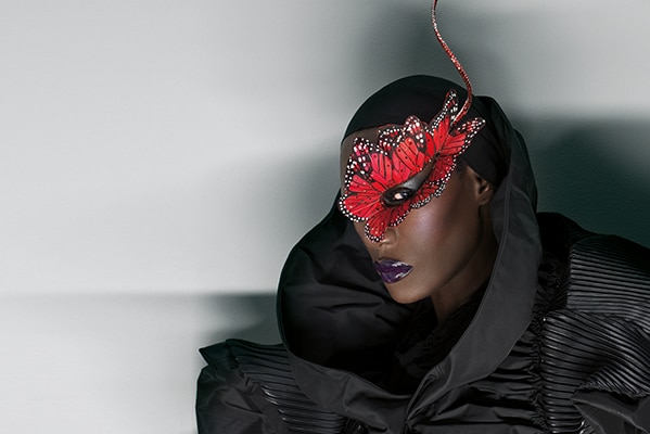 Jamaican singer Grace Jones wears a mask.