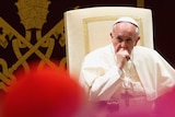 Pope Francis looks on during an audience for Christmas greetings to the Curia