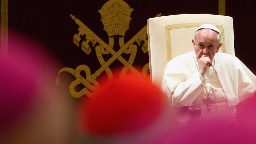 Pope Francis looks on during an audience for Christmas greetings to the Curia