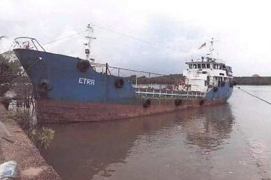 A rusty tanker is seen.