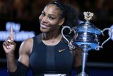 Serena Williams raises a finger and the trophy after winning the Australian Open title in 2017.