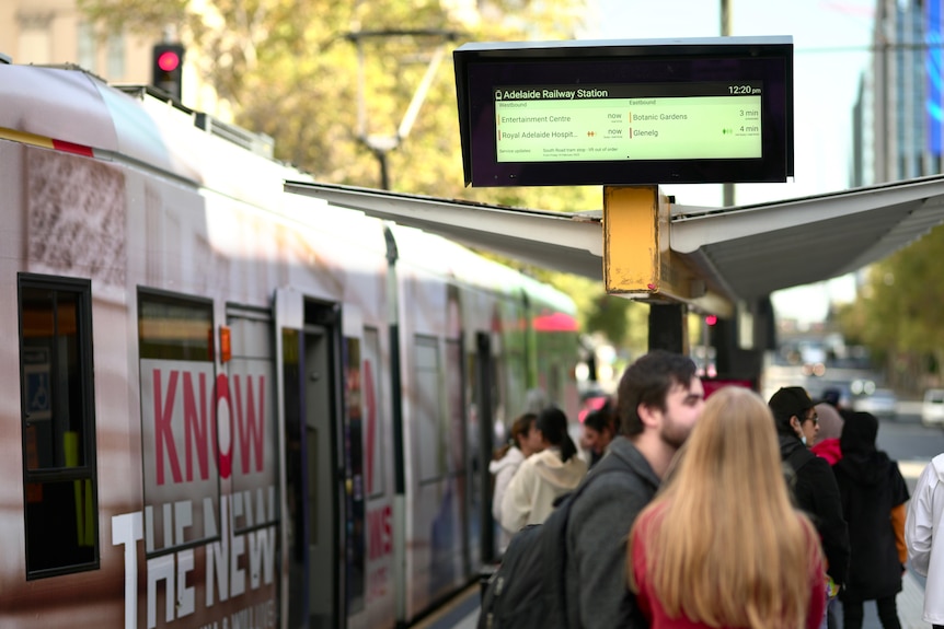 Passengers and a tram at a tram stop in Adelaide's CBD.