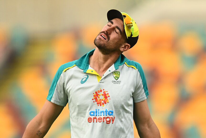 Mitchell Starc closes his eyes and tilts his head to one side
