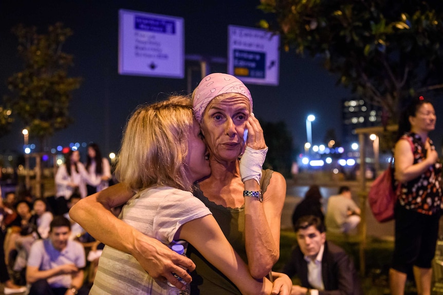 Passengers embrace after multiple explosions at Istanbul airport