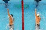 Nathan Adrian (C) of the US swims to victory in the 100m freestyle final.