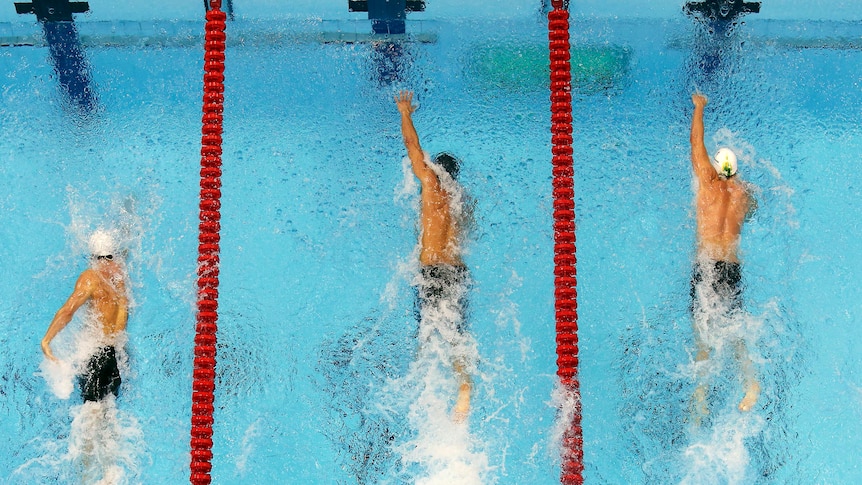 Nathan Adrian (C) of the US swims to victory in the 100m freestyle final.