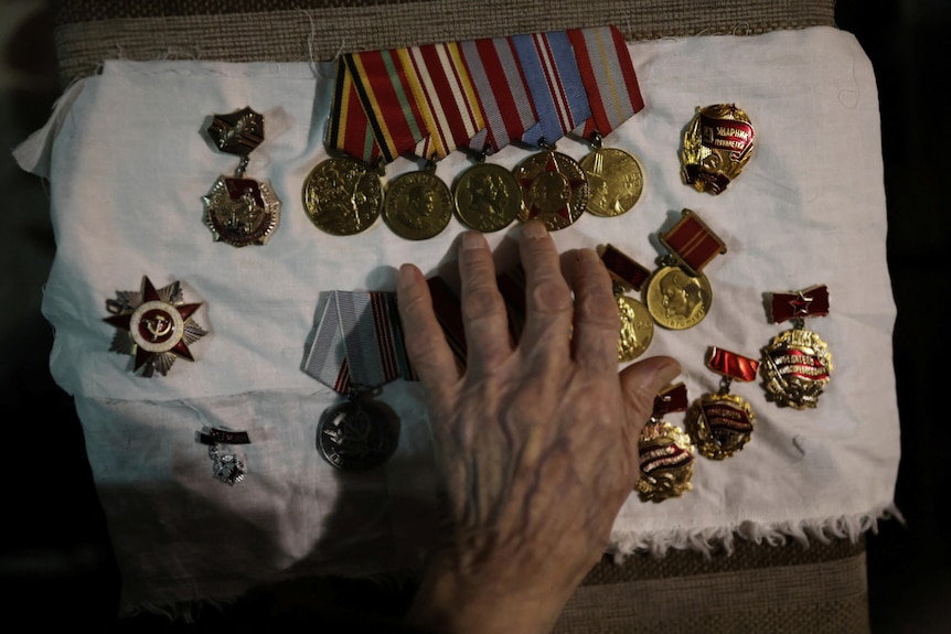 Medals salvaged from Maria's apartment are among her few possessions
