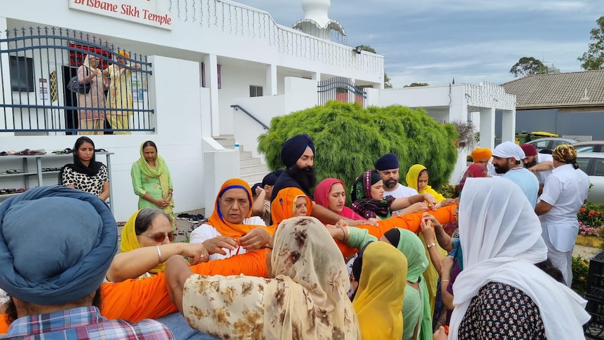 a group in a ceremony outside brisbane's sikh temple