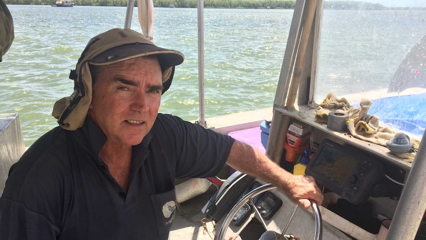 Rob Pender sitting on his barramundi fishing boat.