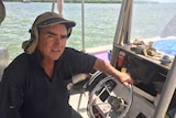 Rob Pender sitting on his barramundi fishing boat.