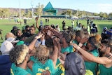 Footy team celebrates in the NT AFL competition