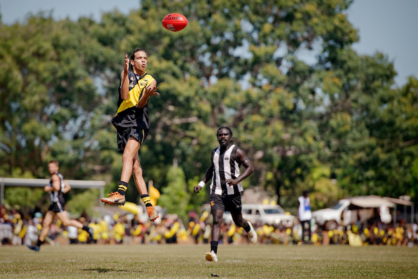 footy player marks the ball