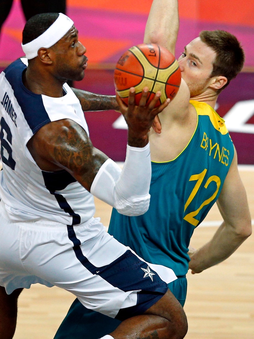 LeBron James (L) of the US shoots past Australia's Aron Baynes during their quarter-final.