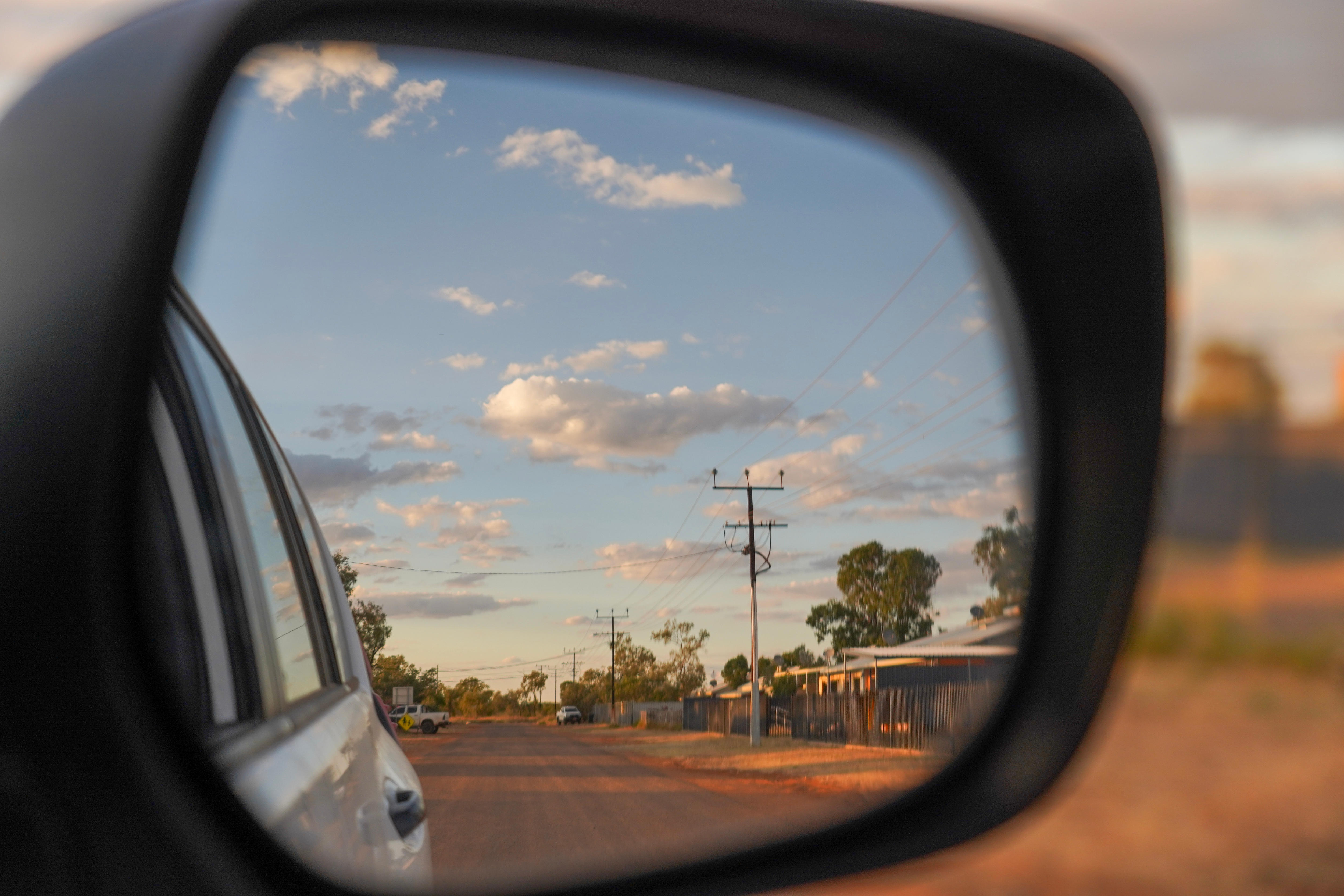 Dirt road through car mirror
