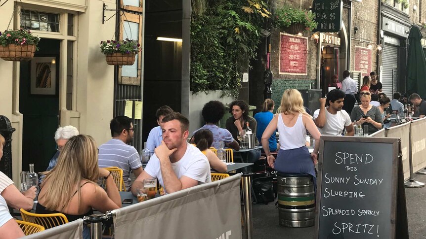 Patrons at a bar near London Bridge.