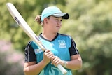Ashleigh Barty holds a cricket bat as she looks at Brisbane Heat coach Andy Richards.