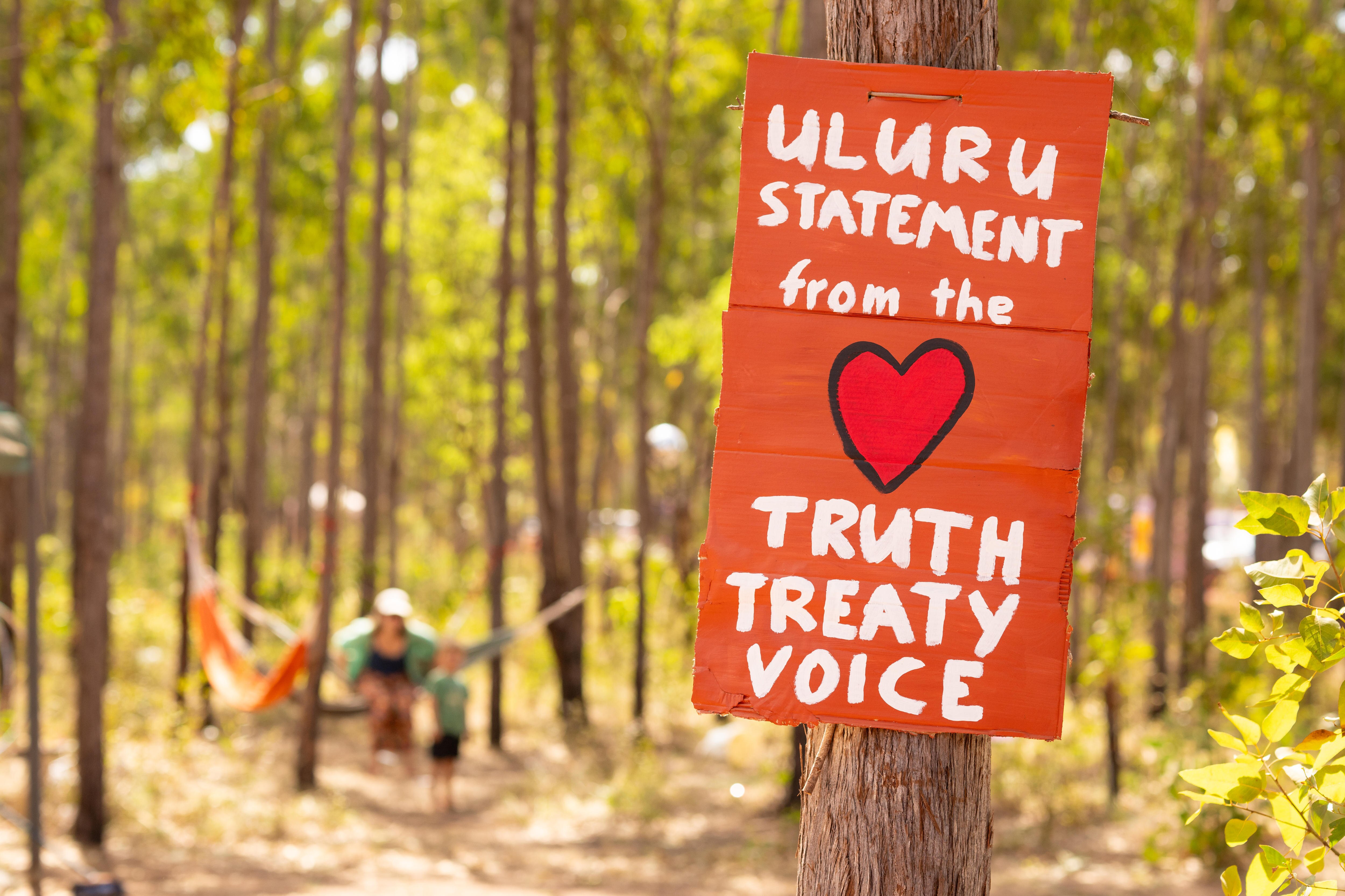 A sign that reads Uluru statement from the heart truth treaty voice. 