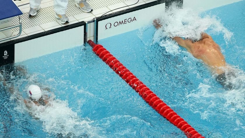 Serbia's Milorad Cavic and US swimmer Michael Phelps reach for the wall