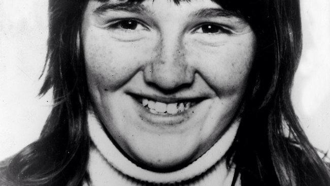 A young girl smiles at the camera.