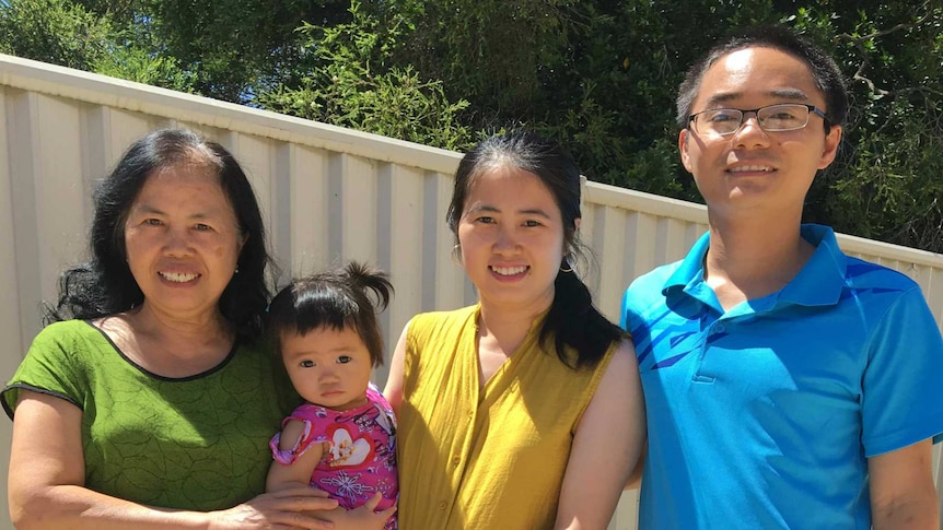 Man next to two women and a small toddler