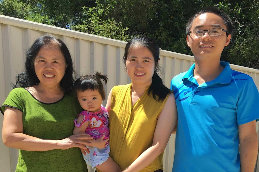 Man next to two women and a small toddler