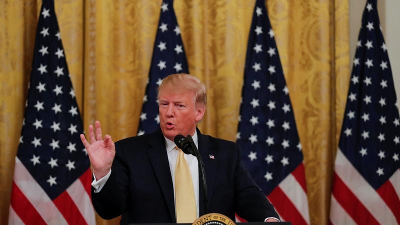 Donald Trump speaks at the lectern