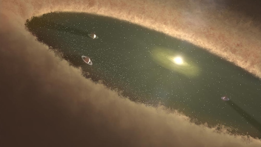 Large disk of dust and gas surrounding a young star with a central region of the disk cleared out by newly forming planets.