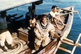 Divers in dive suits on a boat in Darwin Harbour