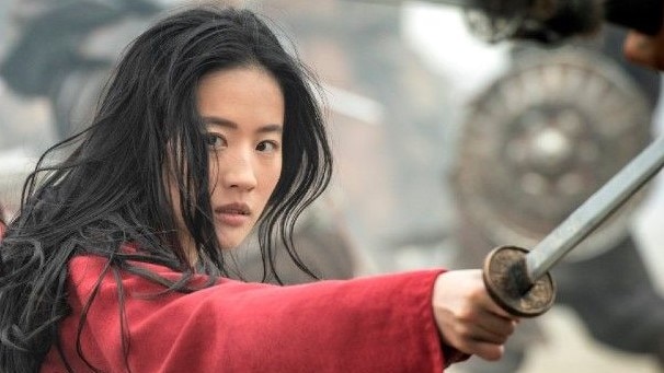 Liu Yifei as Mulan, a woman fighting with a sword, int the Disney movie Mulan