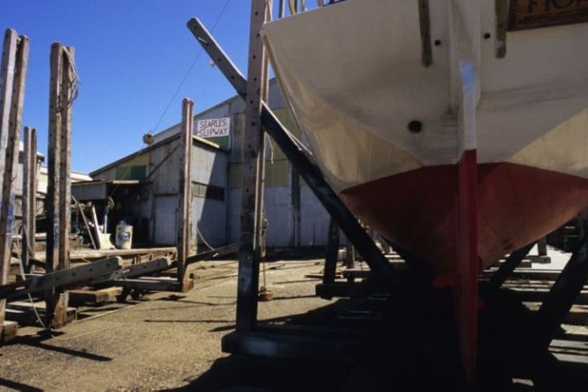 Underneath a boat in the dry dock at a wharf.