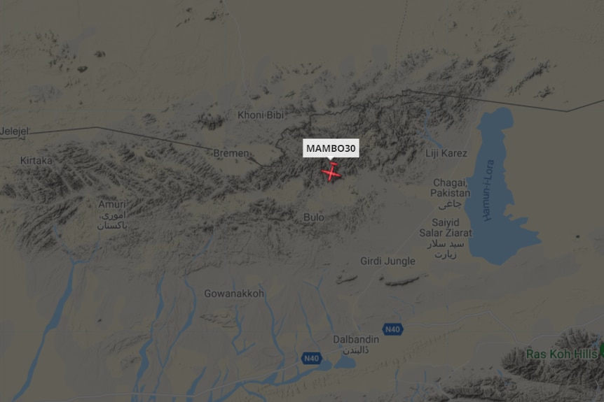 A digital flight tracker shows a small plane icon near the Pakistan-Afghanistan border.