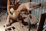 A large wooden sculpture of a goanna 